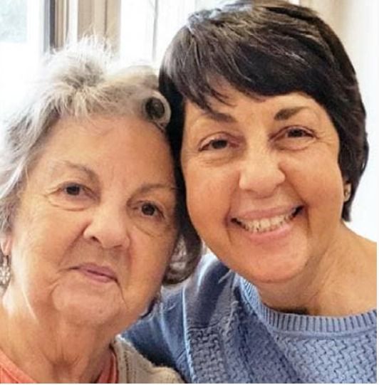 Two women smiling cheek to cheek
